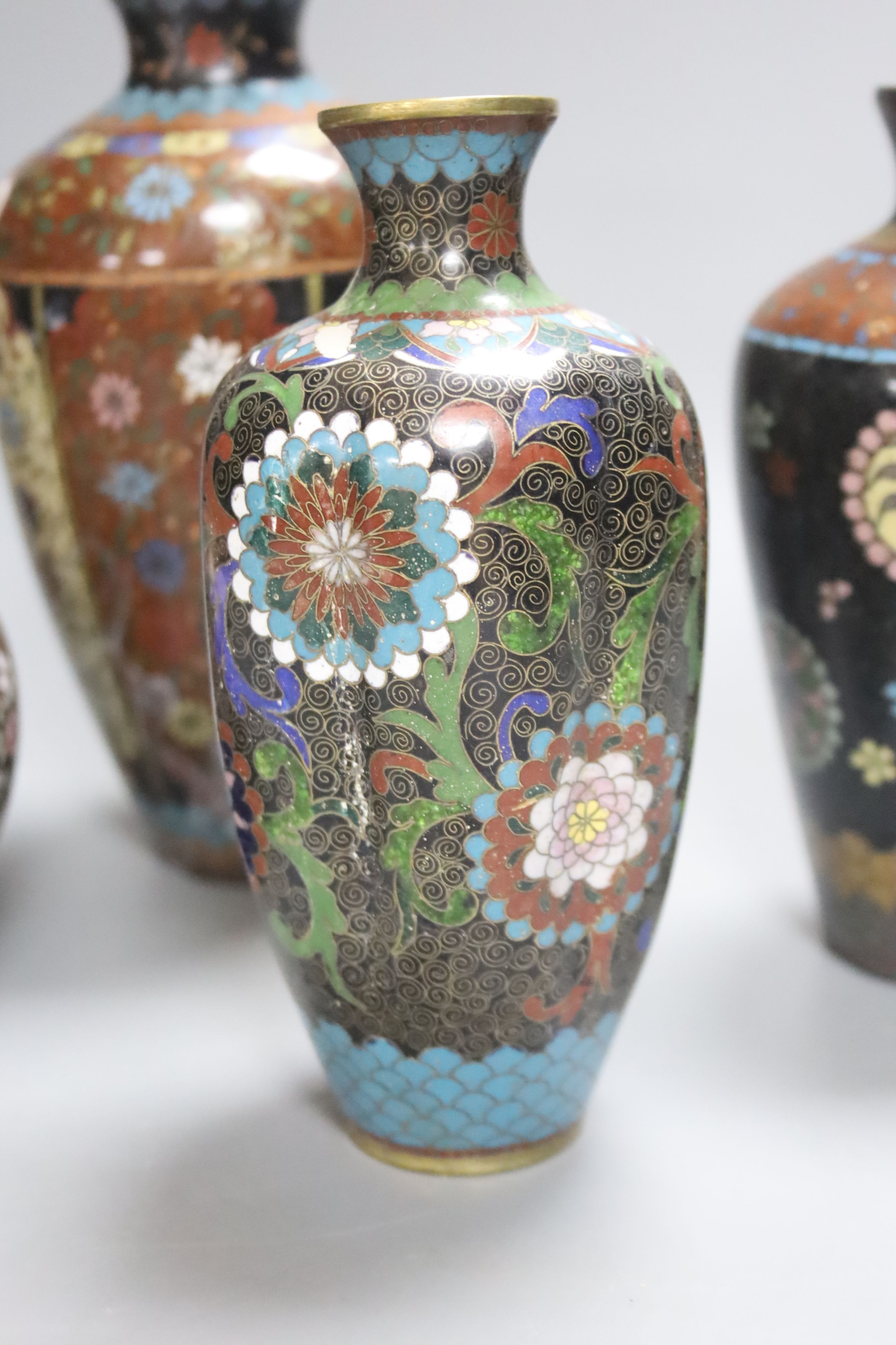 Four Japanese cloisonne vases, together with a similar jar and cover, height 19cm